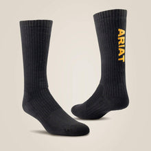  Black socks with 'Ariat' branding on a beige background